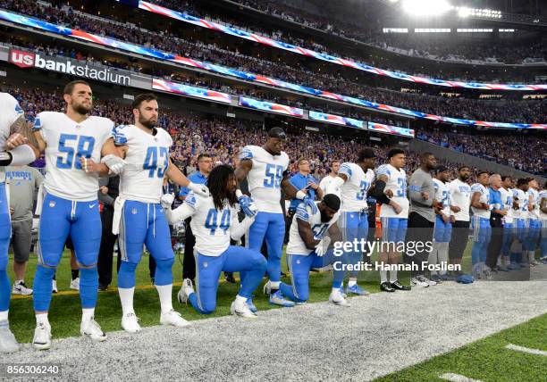 Jalen Reeves-Maybin of the Detroit Lions and teammate Steve Longa take a knee during the national anthem before the game against the Minnesota...