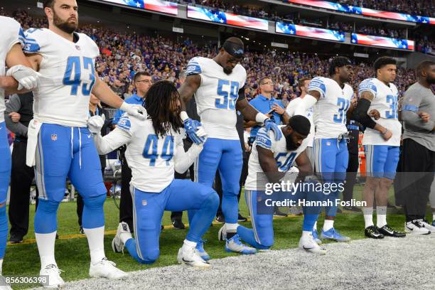 Jalen Reeves-Maybin of the Detroit Lions and teammate Steve Longa take a knee during the national anthem before the game against the Minnesota...