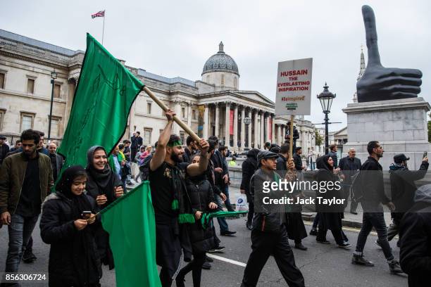 Protesters carry flags and placards during the annual Ashura march on October 1, 2017 in London, England. Thousands of protesters march through...