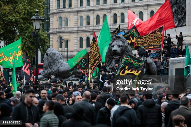 Muslims gather with flags in Trafalgar Square following the annual Ashura march on October 1, 2017 in London, England. Thousands of protesters march...