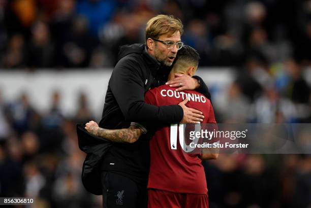 Jurgen Klopp, Manager of Liverpool and Philippe Coutinho of Liverpool embrace after the Premier League match between Newcastle United and Liverpool...