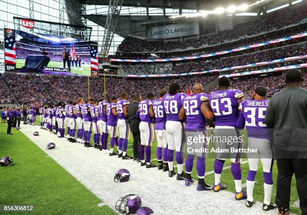 Minnesota Vikings players link arms during the national anthem before the game against the Detroit Lions on October 1, 2017 at U.S. Bank Stadium in...