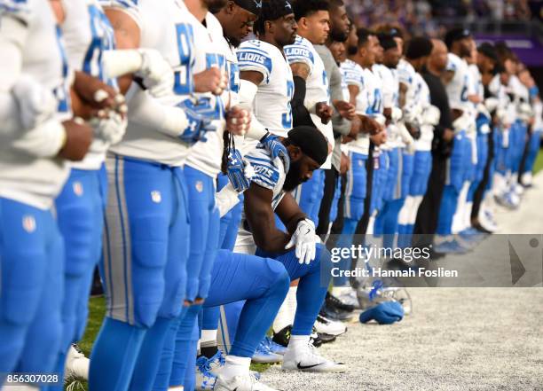 Steve Longa of the Detroit Lions takes a knee with teammate Jalen Reeves-Maybin during the national anthem before the game against the Minnesota...