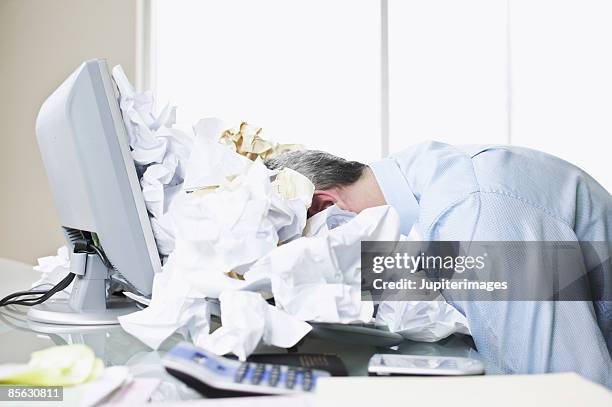 businessman face down in paper pile - grey hair stress stock pictures, royalty-free photos & images