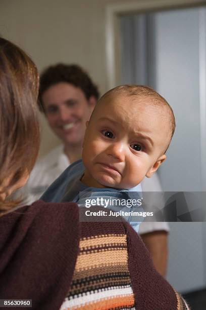 back view of mother and sad baby boy waiting to board airplane - man cry touching stock pictures, royalty-free photos & images