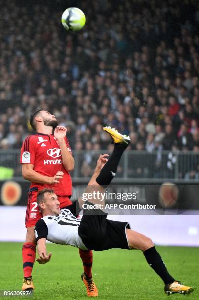 Lyon's French midfielder Lucas Tousart vies with Angers's Algerian defender Mehdi Tahrat during the French L1 football match between Angers and Lyon...