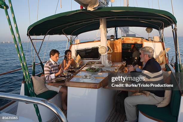 couples dining on sailboat - family trip in laws stock pictures, royalty-free photos & images