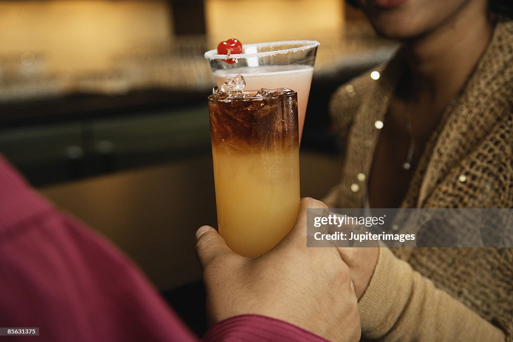 Cropped man and woman toasting