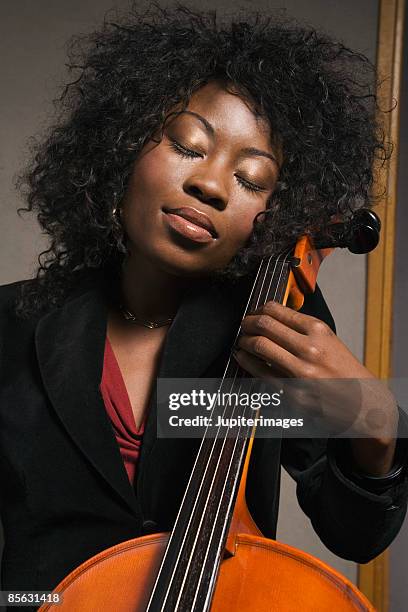 cellist with eyes closed - cellist stock pictures, royalty-free photos & images