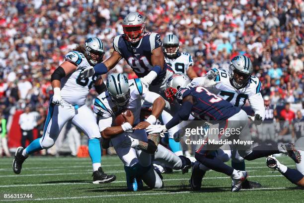 Cam Newton of the Carolina Panthers is tackled by Cassius Marsh of the New England Patriots during the first half at Gillette Stadium on October 1,...