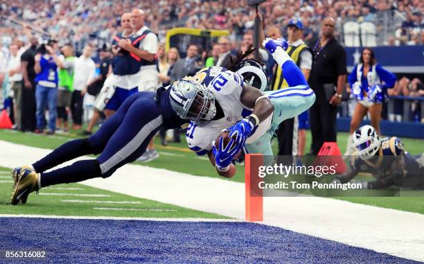 Ezekiel Elliott of the Dallas Cowboys dives into the end zone to score a touchdown against Mark Barron of the Los Angeles Rams in the second quarter...