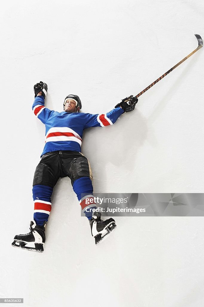 Hockey player lying down on ice