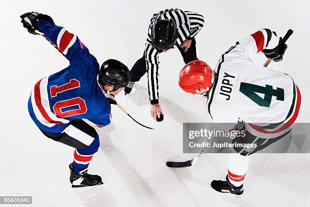 hockey players at face off - hockey puck top view stock pictures, royalty-free photos & images