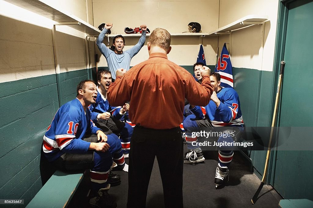 Hockey team in locker room with coach