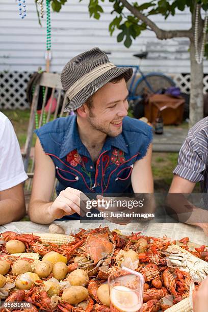 man eating at crab boil - crab seafood stock pictures, royalty-free photos & images