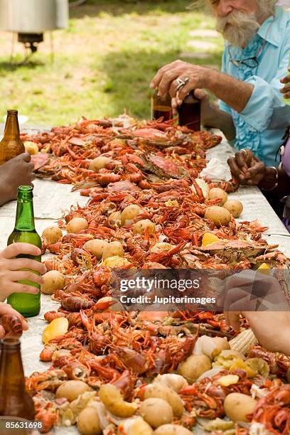 people eating at seafood boil - krabba fisk och skaldjur bildbanksfoton och bilder