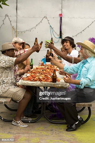 friends toasting at seafood boil - crawfish stockfoto's en -beelden