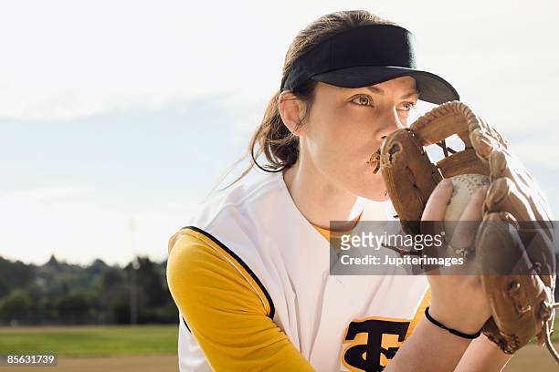 woman in softball uniform - softball glove stock pictures, royalty-free photos & images
