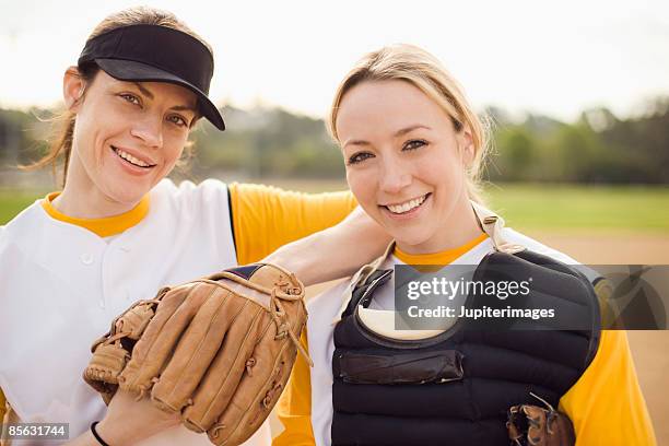 portrait of women on softball team - softball sport stock pictures, royalty-free photos & images