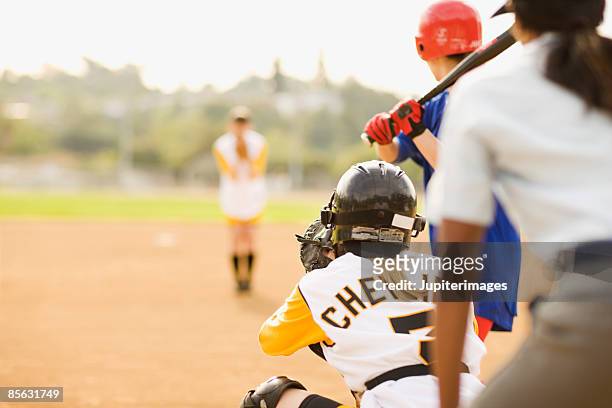 women playing softball - softball stock pictures, royalty-free photos & images