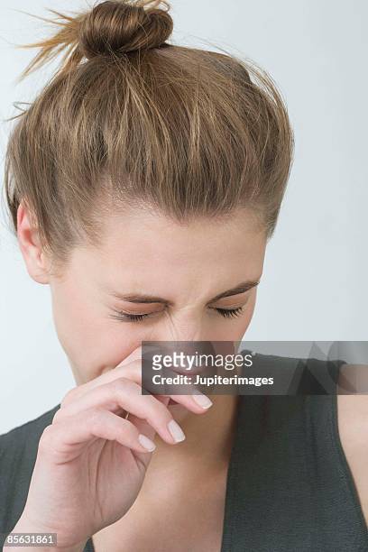 woman sneezing - 鼻をつまむ ストックフォトと画像