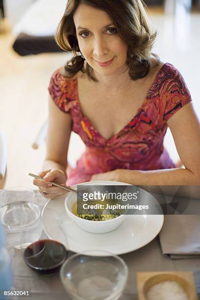 woman eating matzoh ball soup - matzo ball soup stock pictures, royalty-free photos & images
