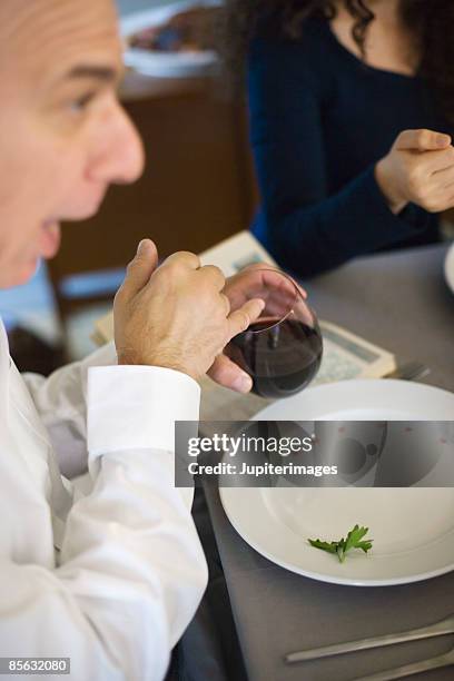 man eating karpas and drinking wine - haggadah stock pictures, royalty-free photos & images
