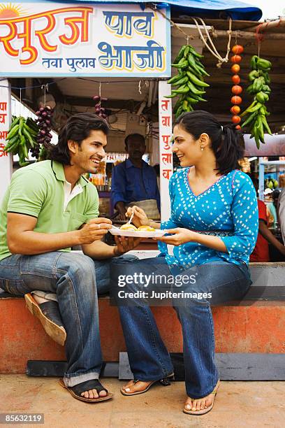 couple eating pau bhajji, india - potato cake stock pictures, royalty-free photos & images