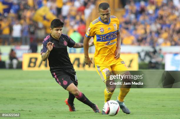 Javier Lopez of Chivas fights for the ball with Rafael Carioca of Tigres during the 12th round match between Tigres UANL and Chivas as part of the...