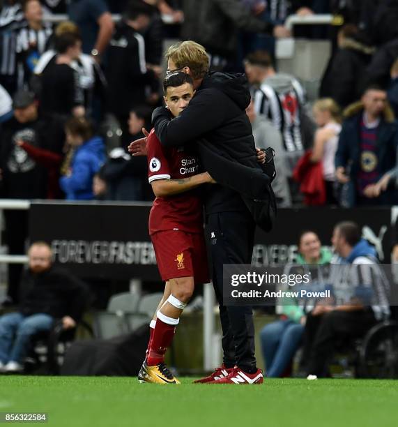 Jurgen Klopp manager of Liverpool embraces Philippe Coutinho of Liverpool at the end of the Premier League match between Newcastle United and...