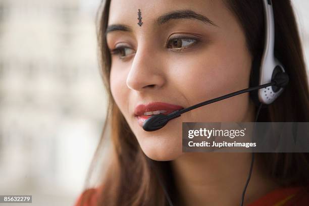 businesswoman wearing headset - tilaka stock pictures, royalty-free photos & images