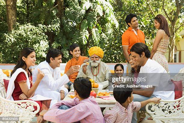 family engaged in conversation - rajasthani youth stockfoto's en -beelden