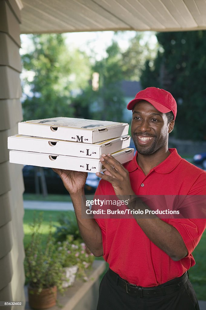 Smiling man delivering pizza