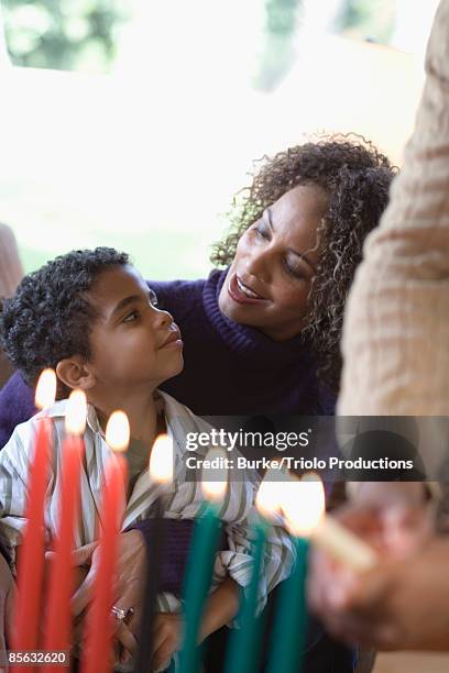 mother talking to her son about kwanzaa - kwanzaa fotografías e imágenes de stock