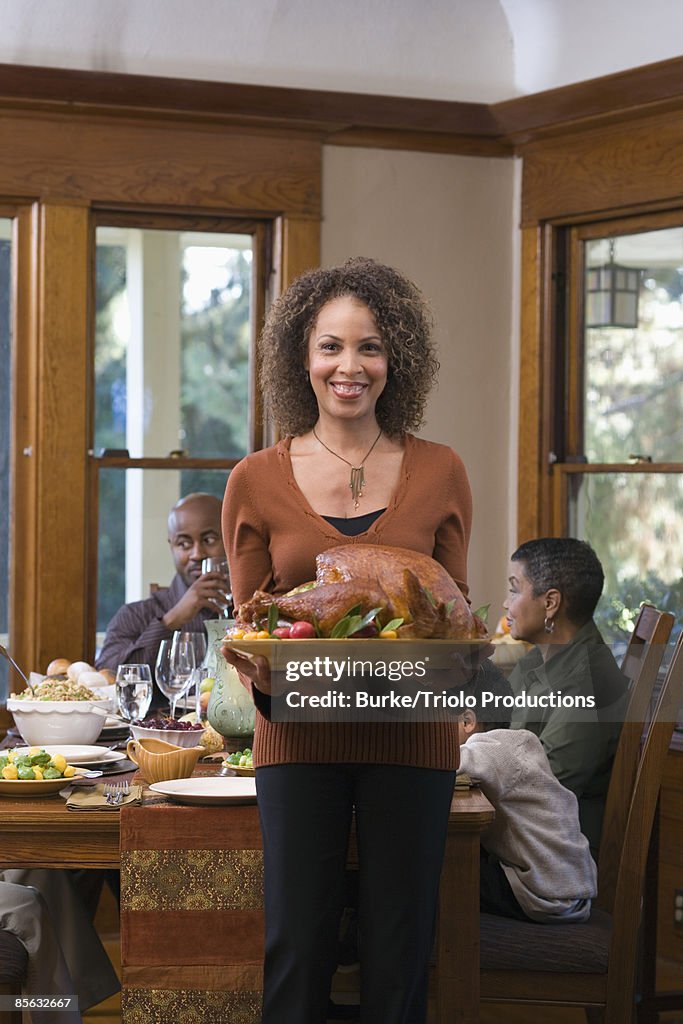 Woman holding roast turkey