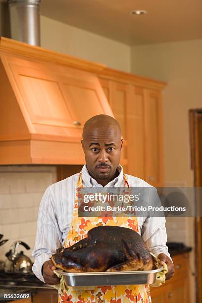 man holding burned turkey - funny rooster stockfoto's en -beelden