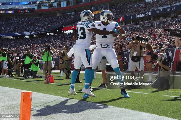 Fozzy Whittaker of the Carolina Panthers celebrates with Cam Newton after scoring a touchdown during the second quarter against the New England...