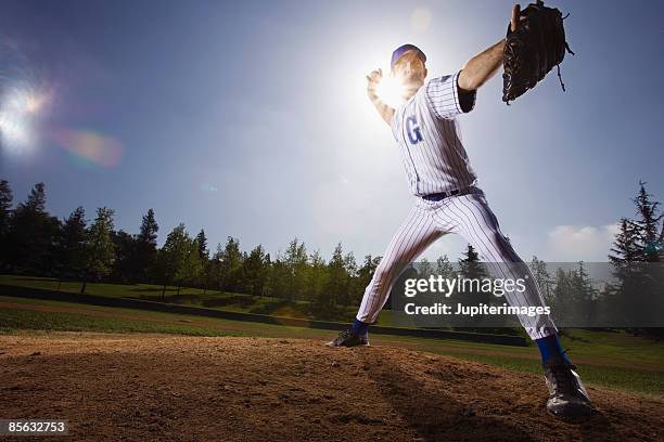 serious pitcher throwing baseball from pitcher's mound - baseball pitchers mound - fotografias e filmes do acervo