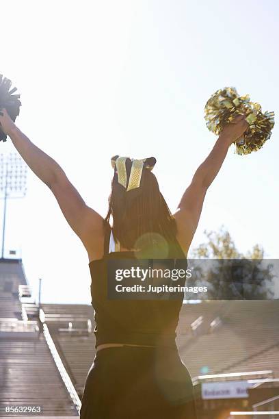 cheerleader cheering - pom pom stock-fotos und bilder