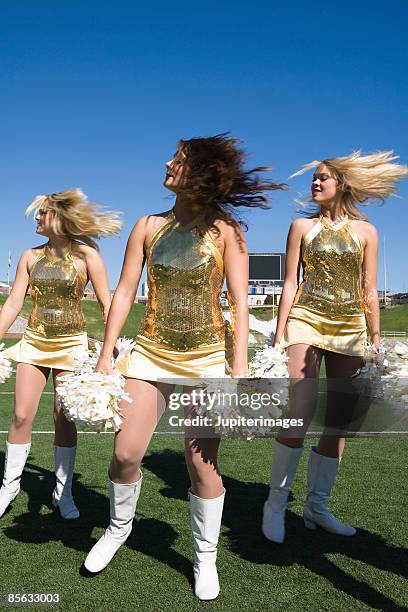 cheerleaders cheering - cheerleaders stock pictures, royalty-free photos & images