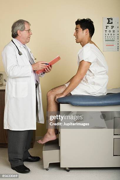 doctor examining patient - doctor profile view stock pictures, royalty-free photos & images