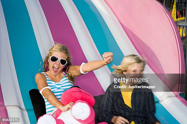 girl and boy on slide - girl open mouth stockfoto's en -beelden