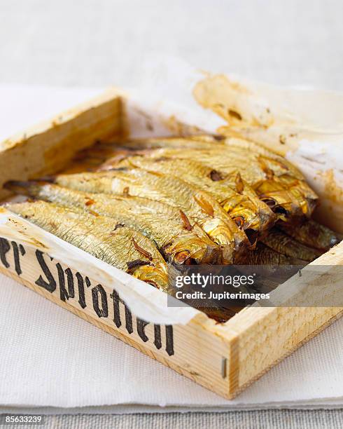 dry sprat fish in wood crate - sprat fish stock pictures, royalty-free photos & images