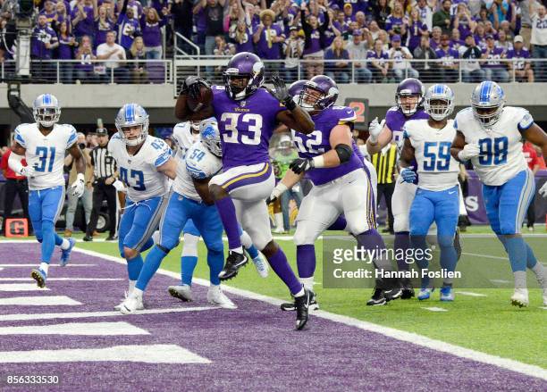 Dalvin Cook of the Minnesota Vikings scores a five yard rushing touchdown in the second quarter of the game against the Detroit Lions on October 1,...