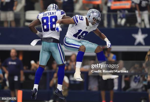 Brice Butler of the Dallas Cowboys celebrates his touchdown with Dez Bryant in the second quarter against the Los Angeles Rams at AT&T Stadium on...