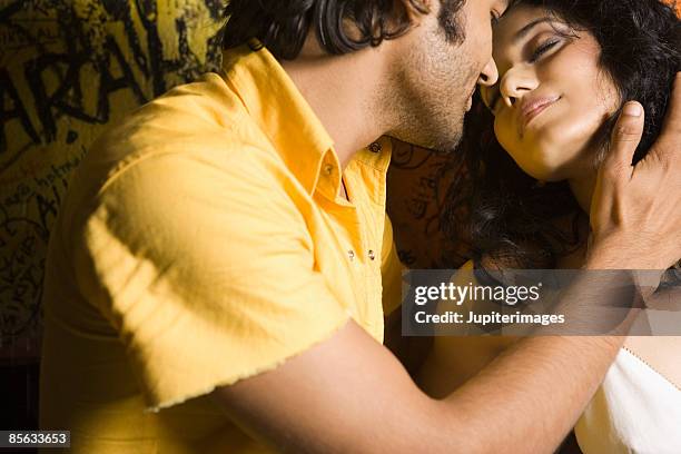 couple in intimate pose in nightclub - indian couple foto e immagini stock