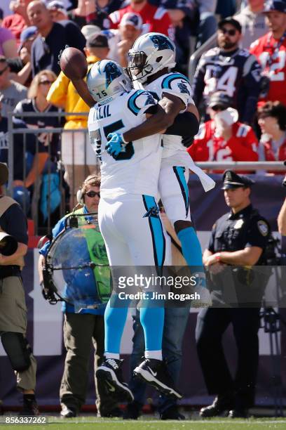 Fozzy Whittaker of the Carolina Panthers celebrates with Matt Kalil after scoring a touchdown during the second quarter against the New England...
