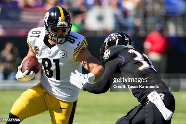Jesse James of the Pittsburgh Steelers tries to get around Eric Weddle of the Baltimore Ravens in the first quarter at M&T Bank Stadium on October 1,...