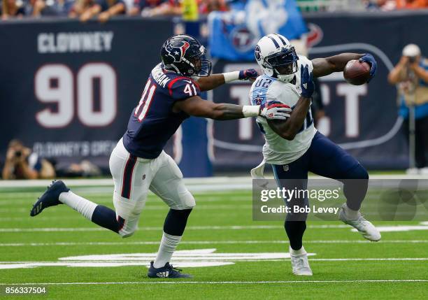 Delanie Walker of the Tennessee Titans runs with the ball after a reception as Zach Cunningham of the Houston Texans attempts to tackle in the second...