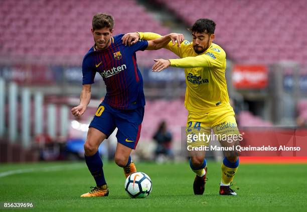 Sergi Roberto of Barcelona competes for the ball with Tana of Las Palmas during the La Liga match between Barcelona and Las Palmas at Camp Nou on...